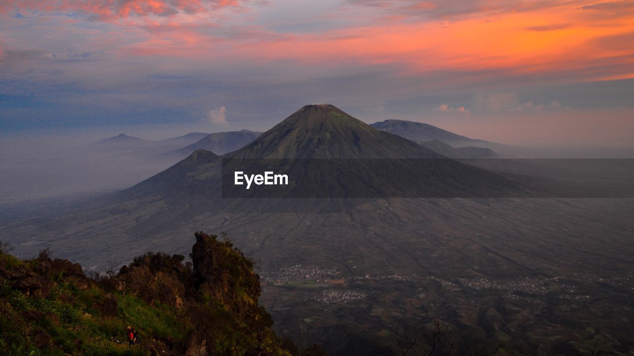 Scenic view of volcanic landscape against sky during sunset