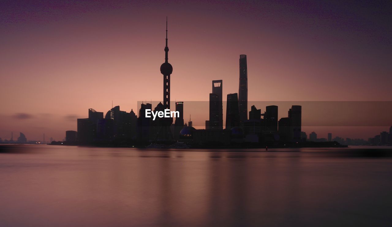 CITY BUILDINGS AGAINST SKY DURING SUNSET