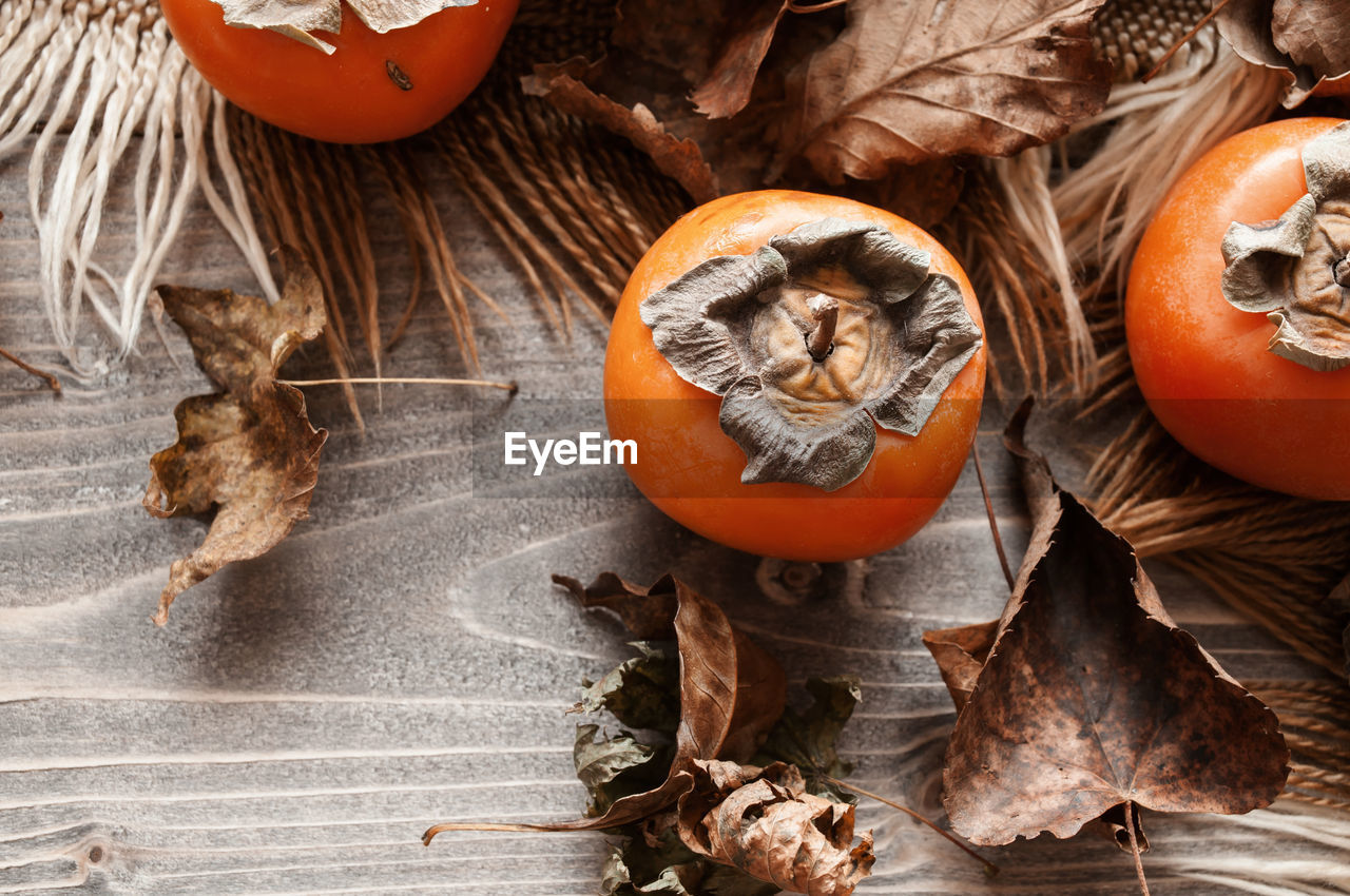 PUMPKINS ON DRY LEAVES AT TABLE