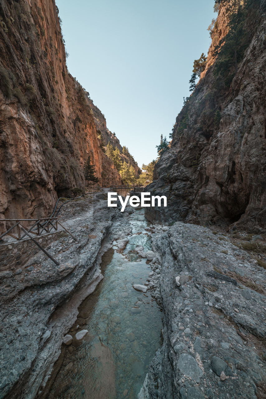 ROCK FORMATIONS ON MOUNTAIN AGAINST SKY