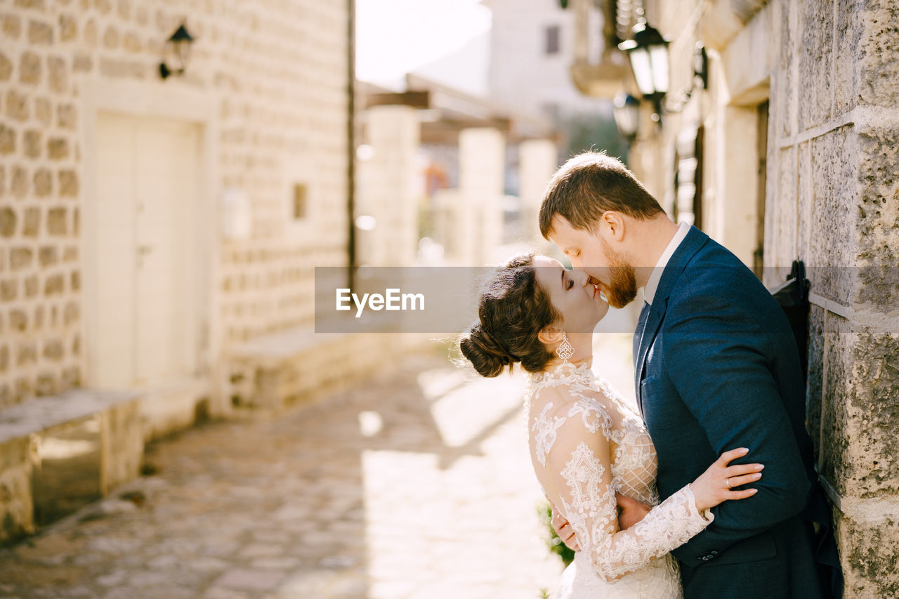 side view of young couple standing outdoors