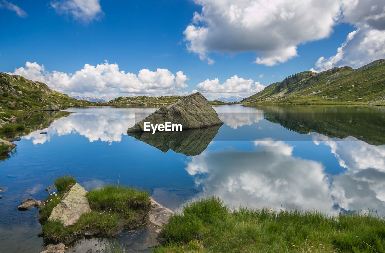 PANORAMIC VIEW OF LAKE AMIDST PLANTS AGAINST SKY