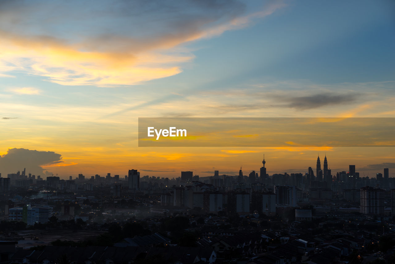 Cityscape against sky during sunset