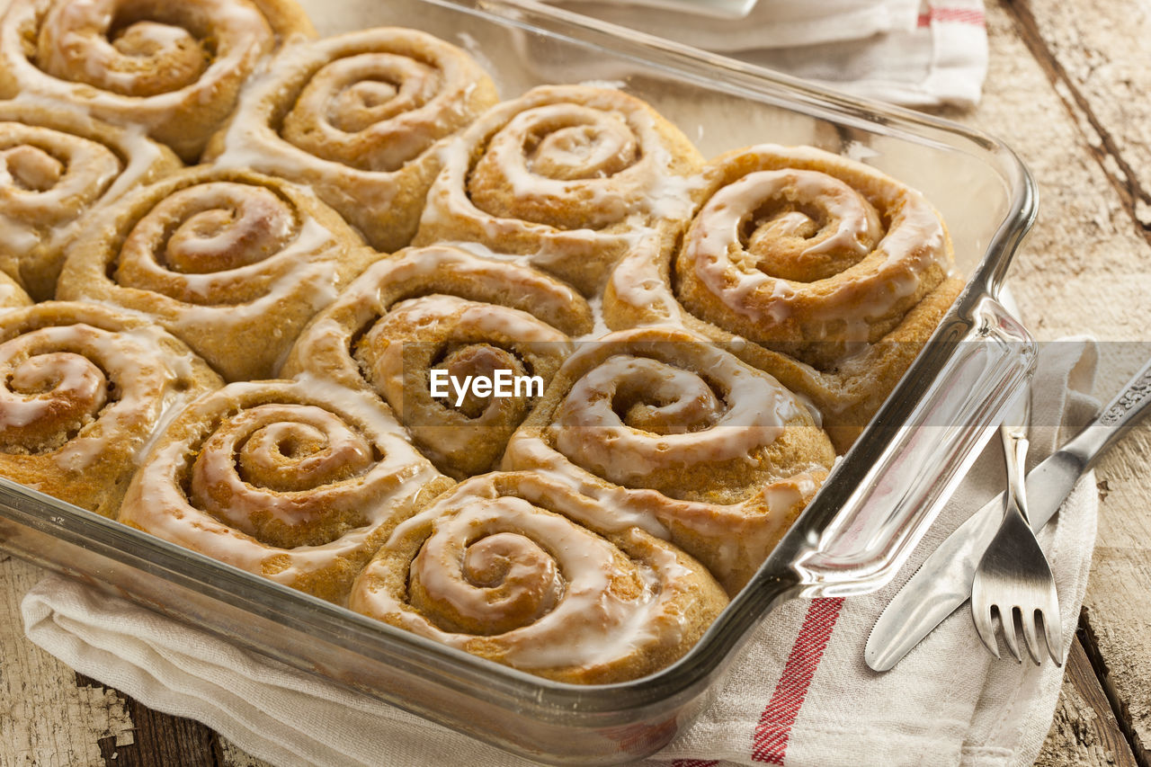 food, food and drink, sweet food, baked, dessert, sweet, freshness, dish, kitchen utensil, cinnamon roll, high angle view, baking sheet, indoors, no people, temptation, baking pan, cookie, still life, dough, baked pastry item, produce, cake, tray, celebration, wax paper, eating utensil, tradition, pie