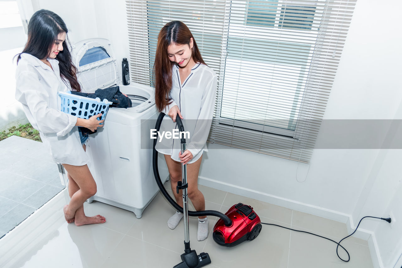 Lesbian couple doing housework in home