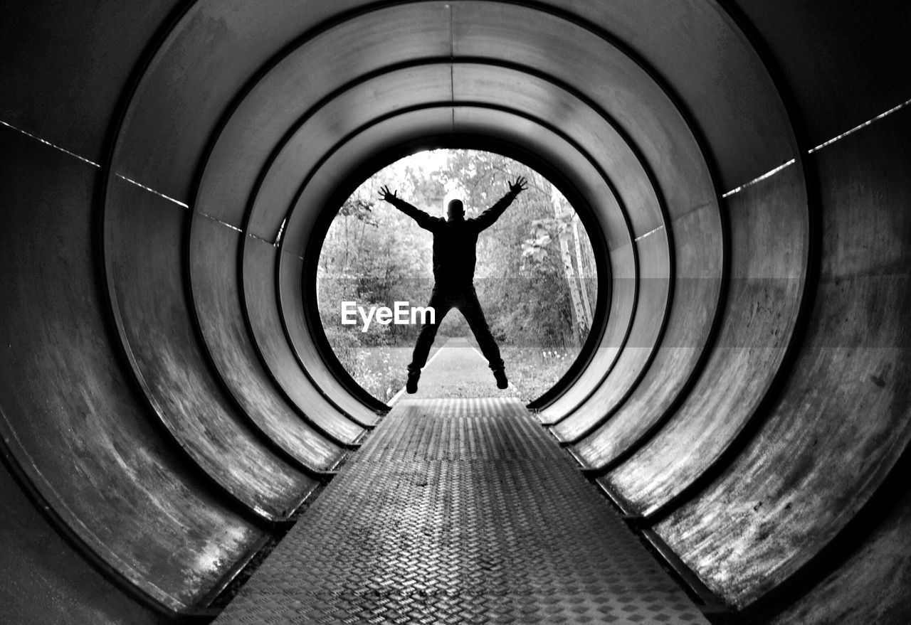 Man jumping in the tunnel toward to the exit