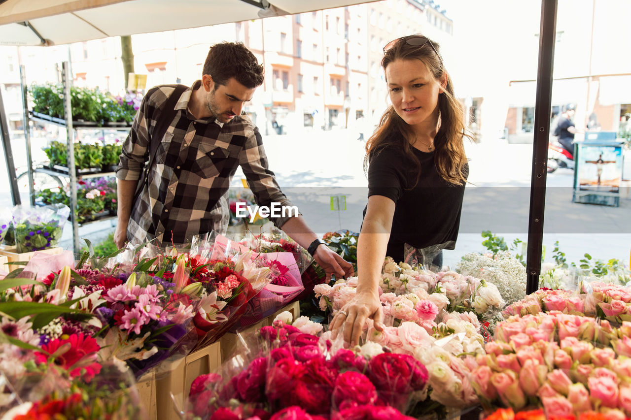 Couple choosing flowers at market