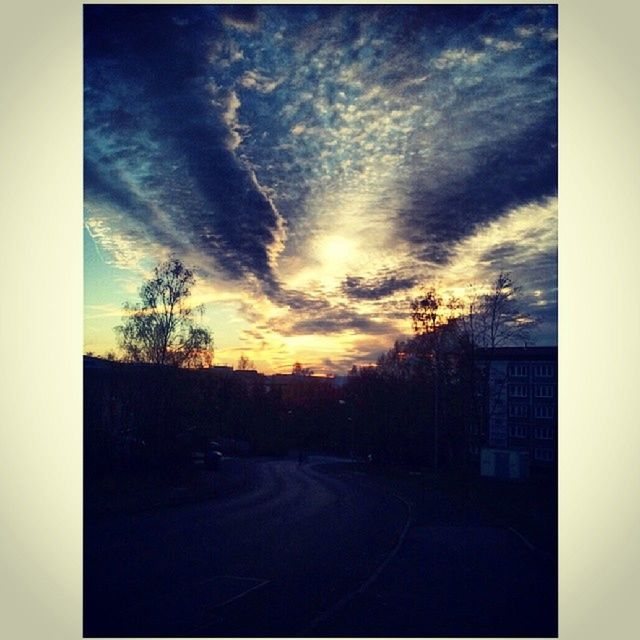 VIEW OF ROAD AGAINST CLOUDY SKY