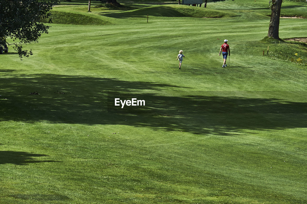 Father and son on golf course