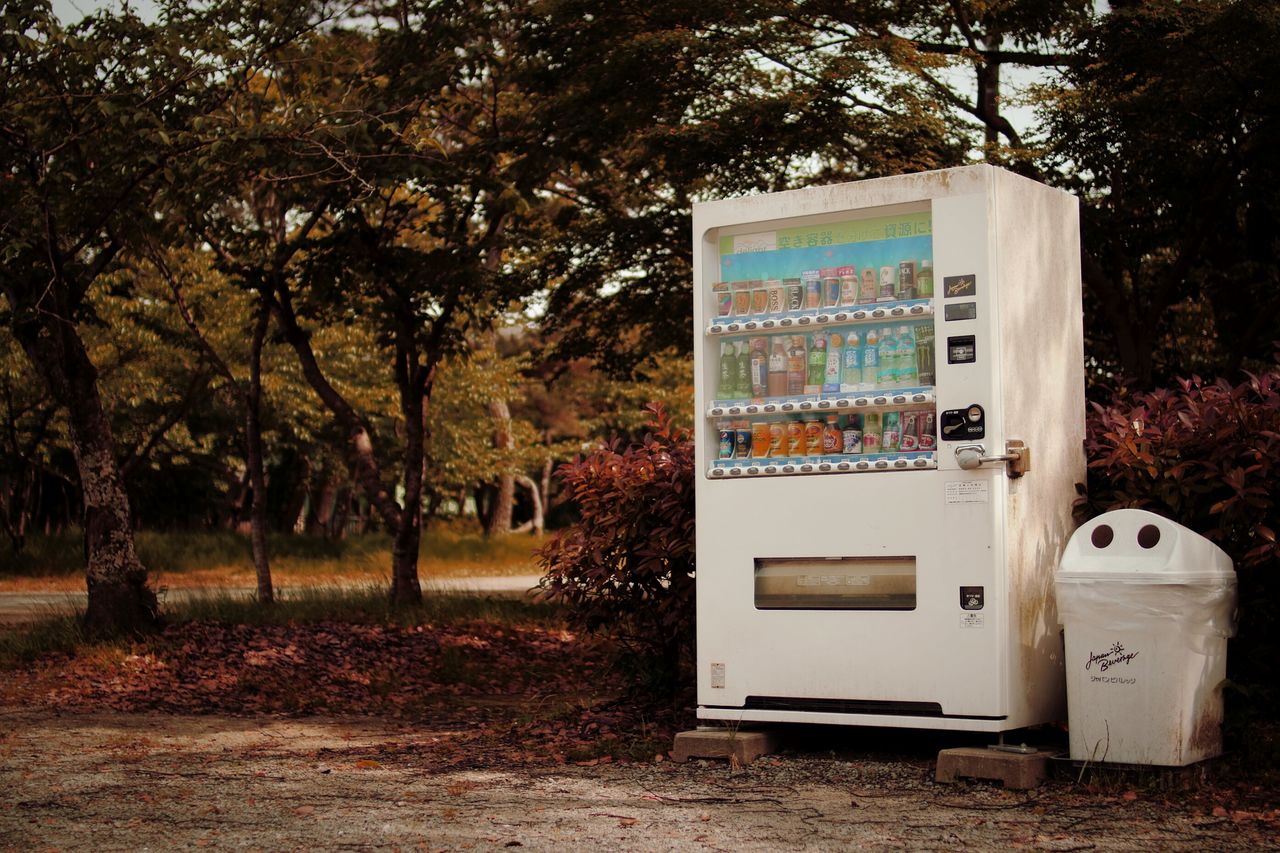 Vending machine against trees in park