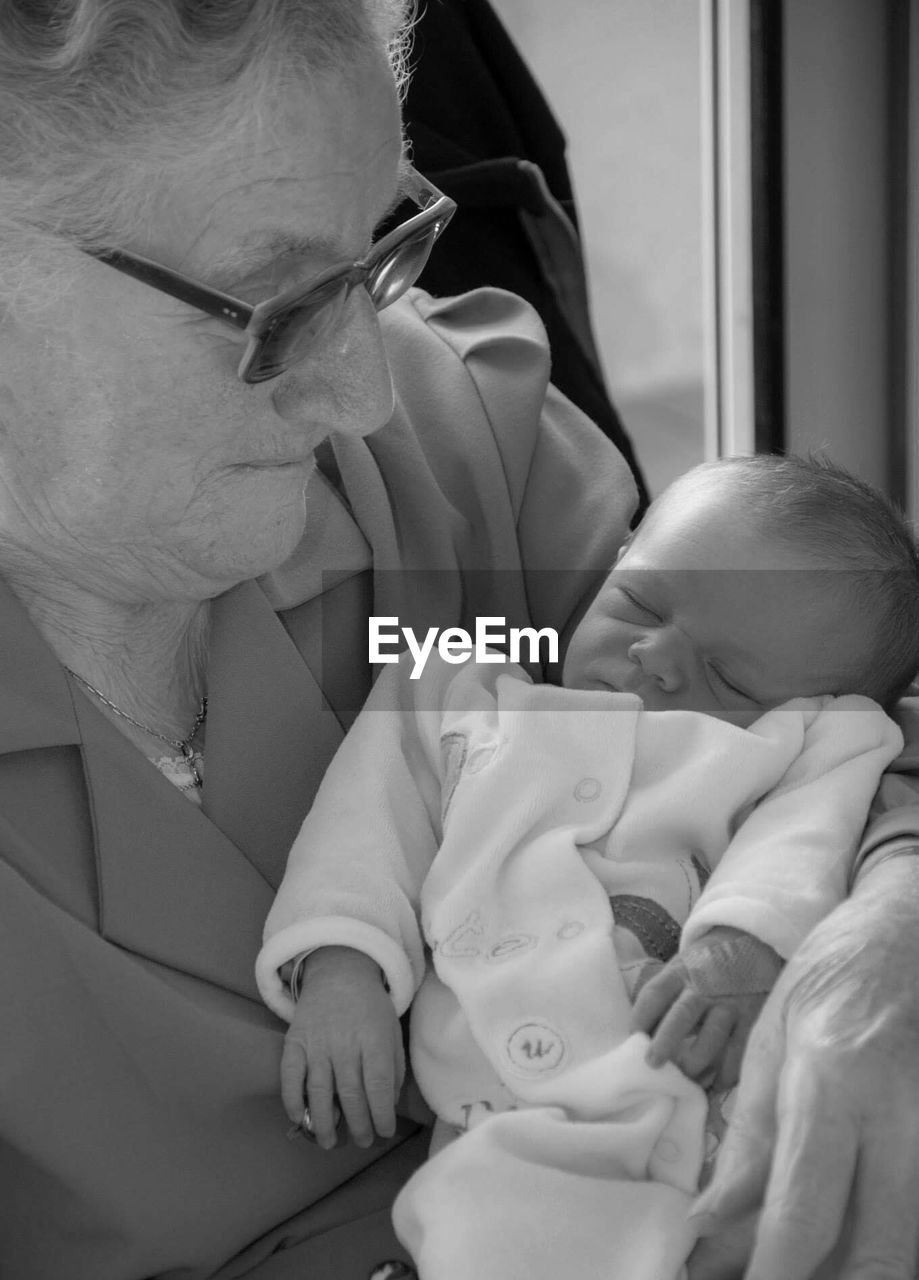 Close-up of grandmother holding baby girl