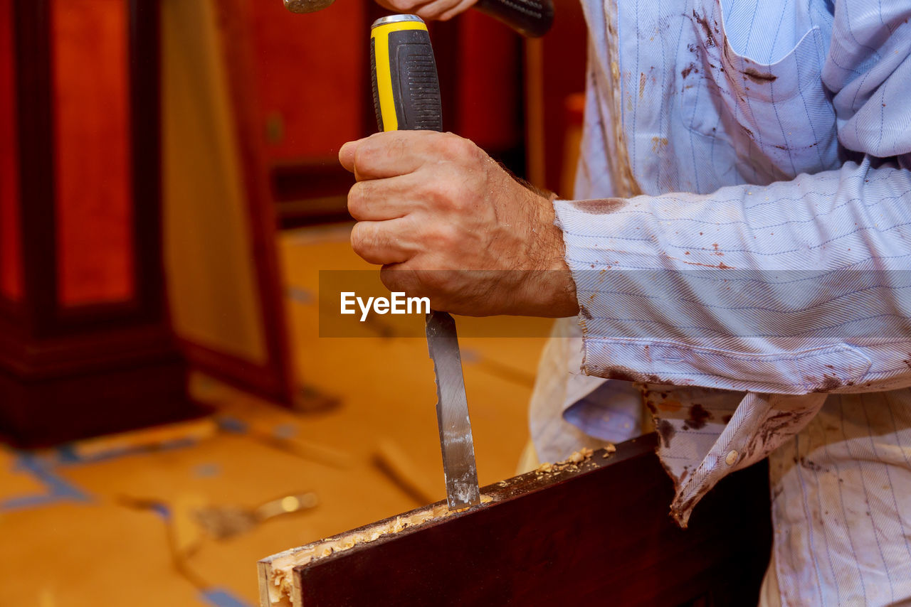 Midsection of carpenter fixing door