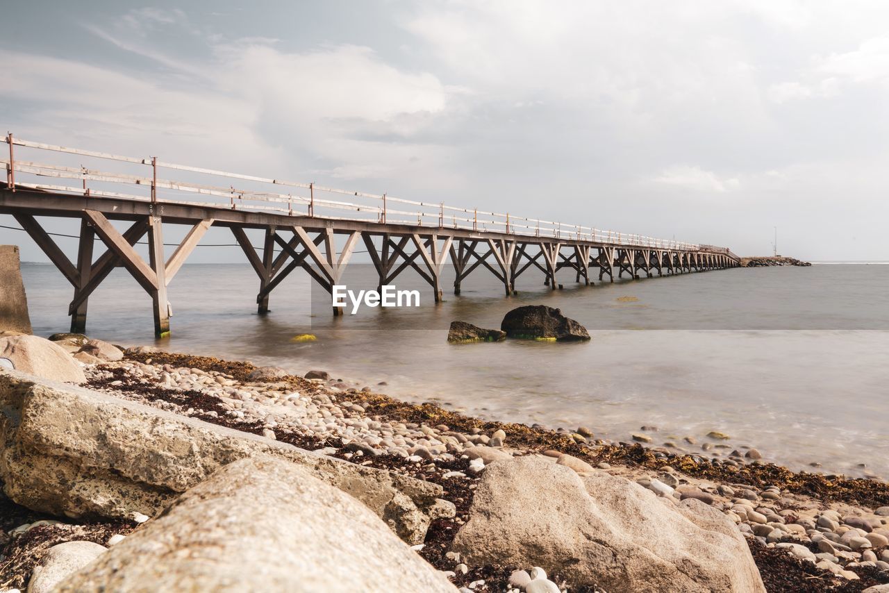 Bridge over sea against sky