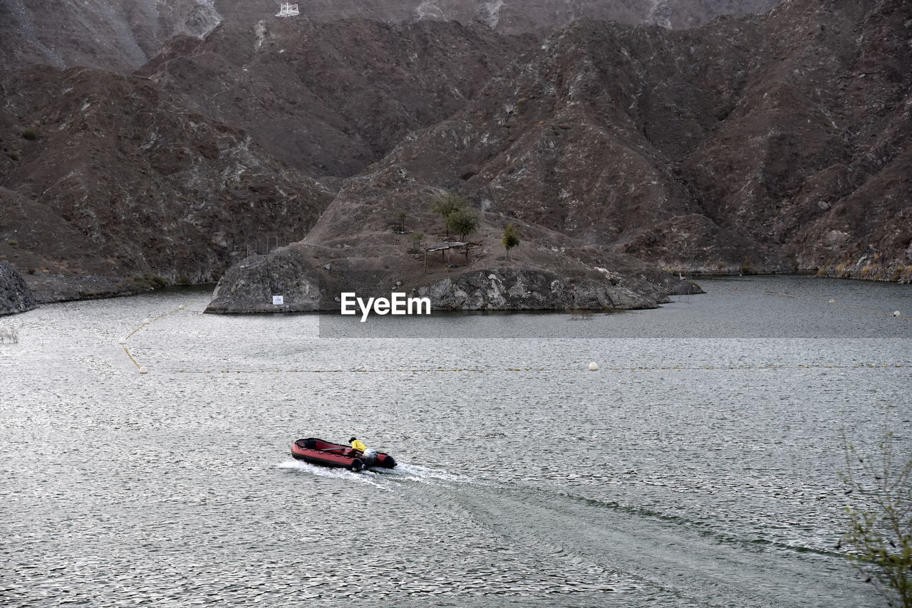 Scenic view of river amidst mountains