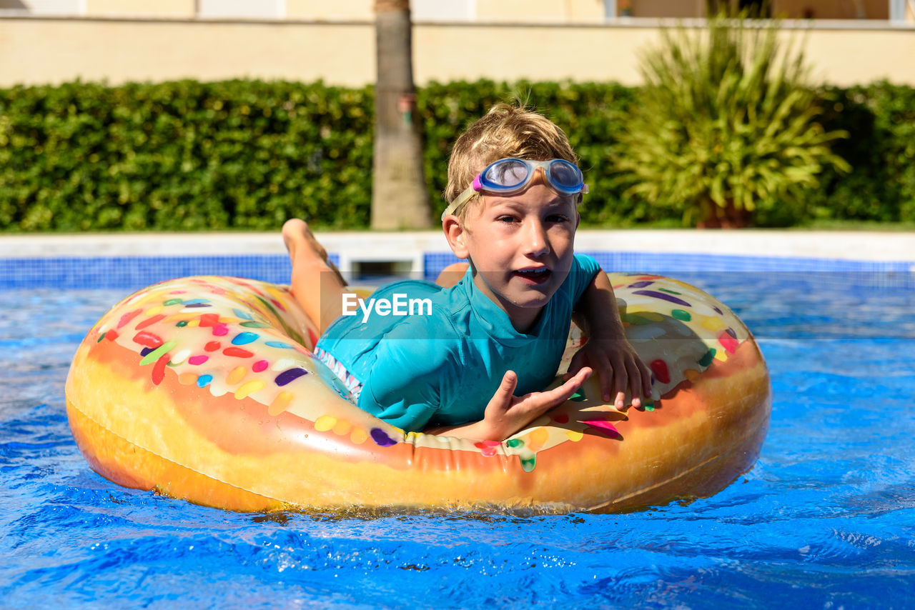 Portrait of smiling boy in swimming pool