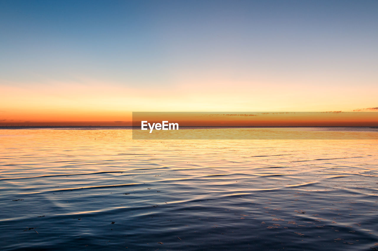 SCENIC VIEW OF SEA DURING SUNSET