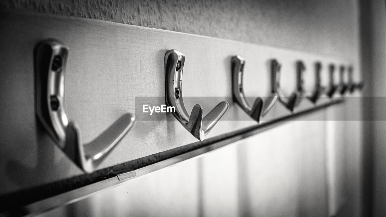 Close up of coat hooks in black and white. 