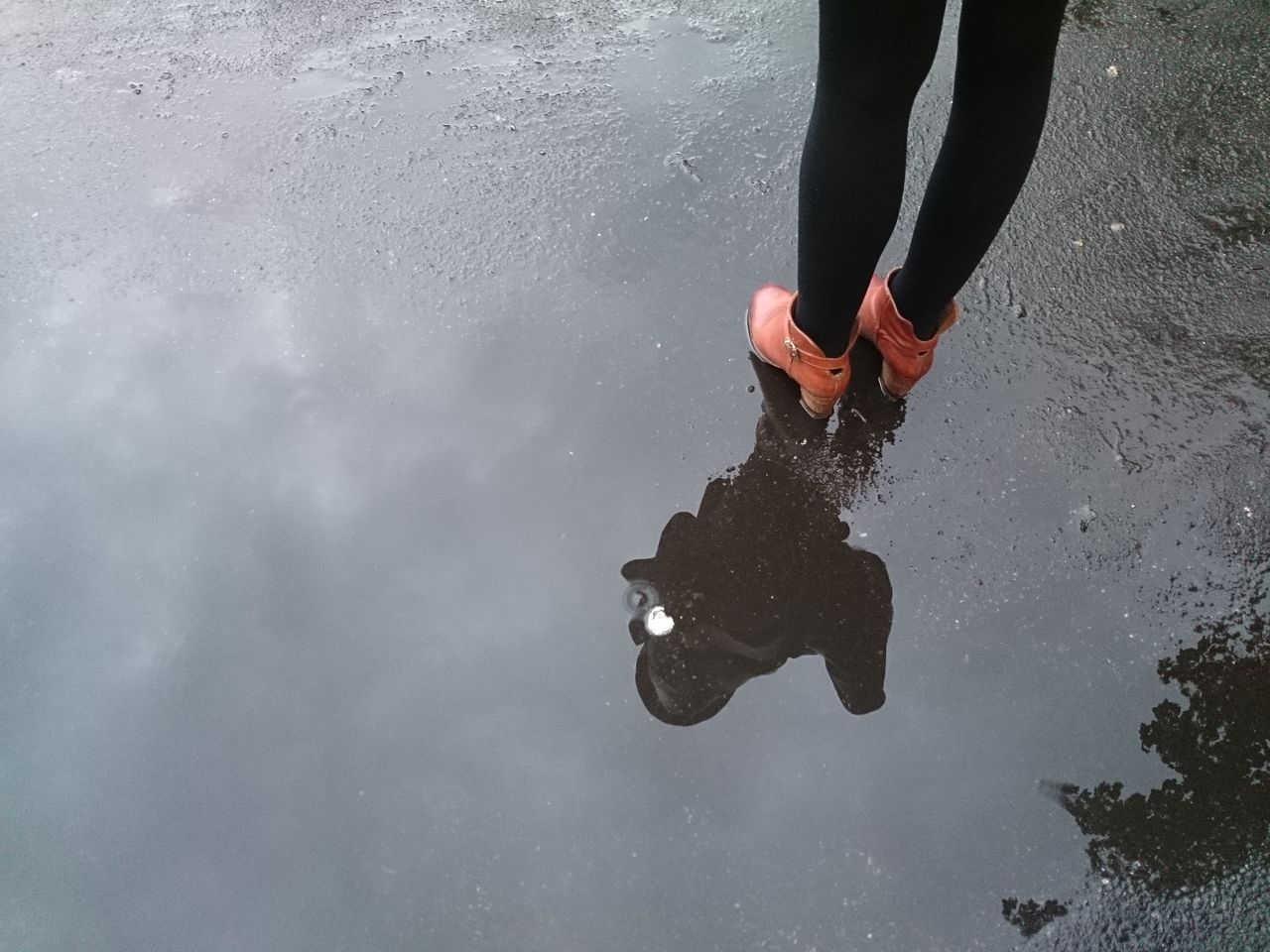 Woman standing in puddle