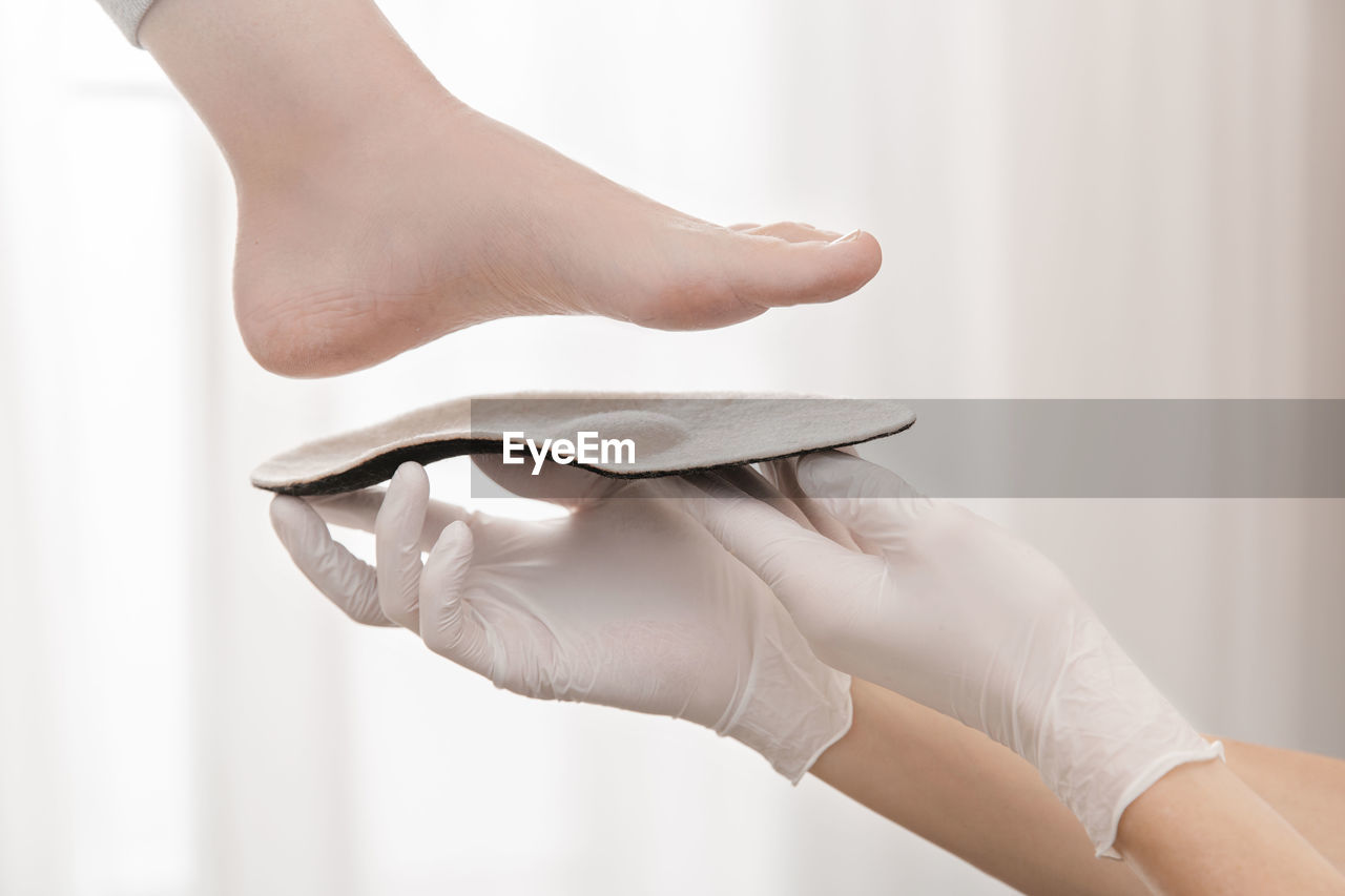 Hands of woman measuring sole