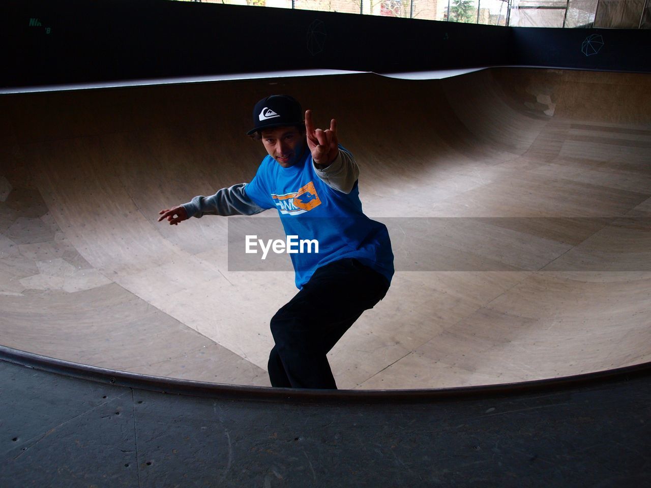 FULL LENGTH OF MAN SKATEBOARDING ON SKATEBOARD