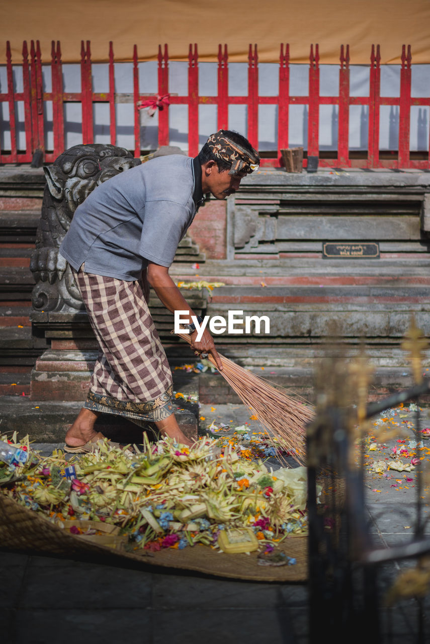 MAN WORKING IN TRADITIONAL CLOTHING