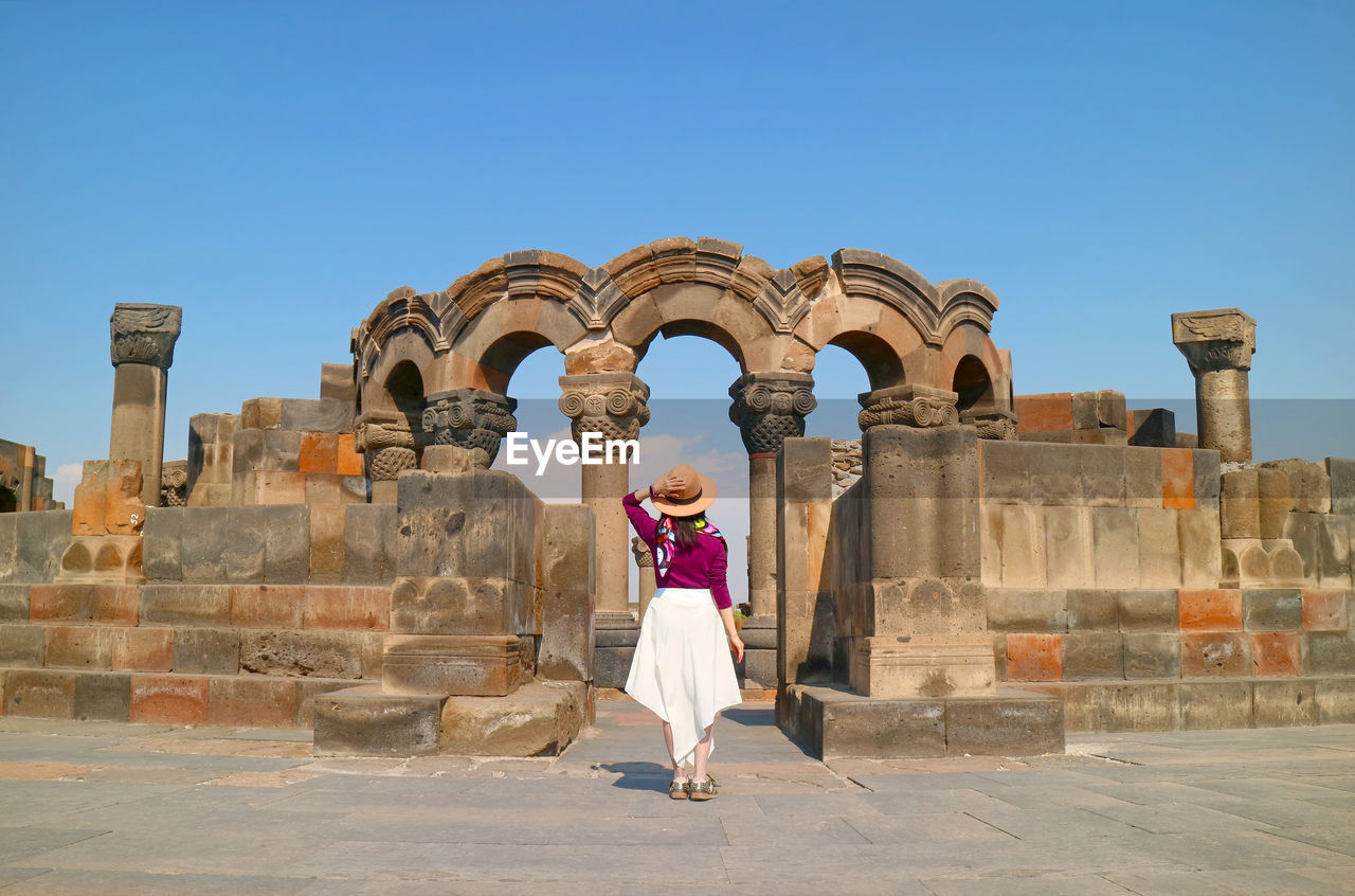Female visitor at the amazing zvartnots cathedral in armavir province of armenia