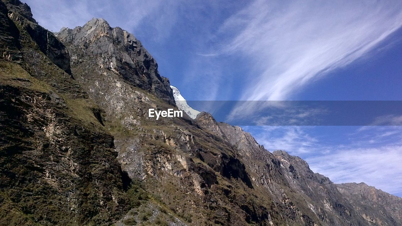 LOW ANGLE VIEW OF ROCKY MOUNTAINS AGAINST SKY