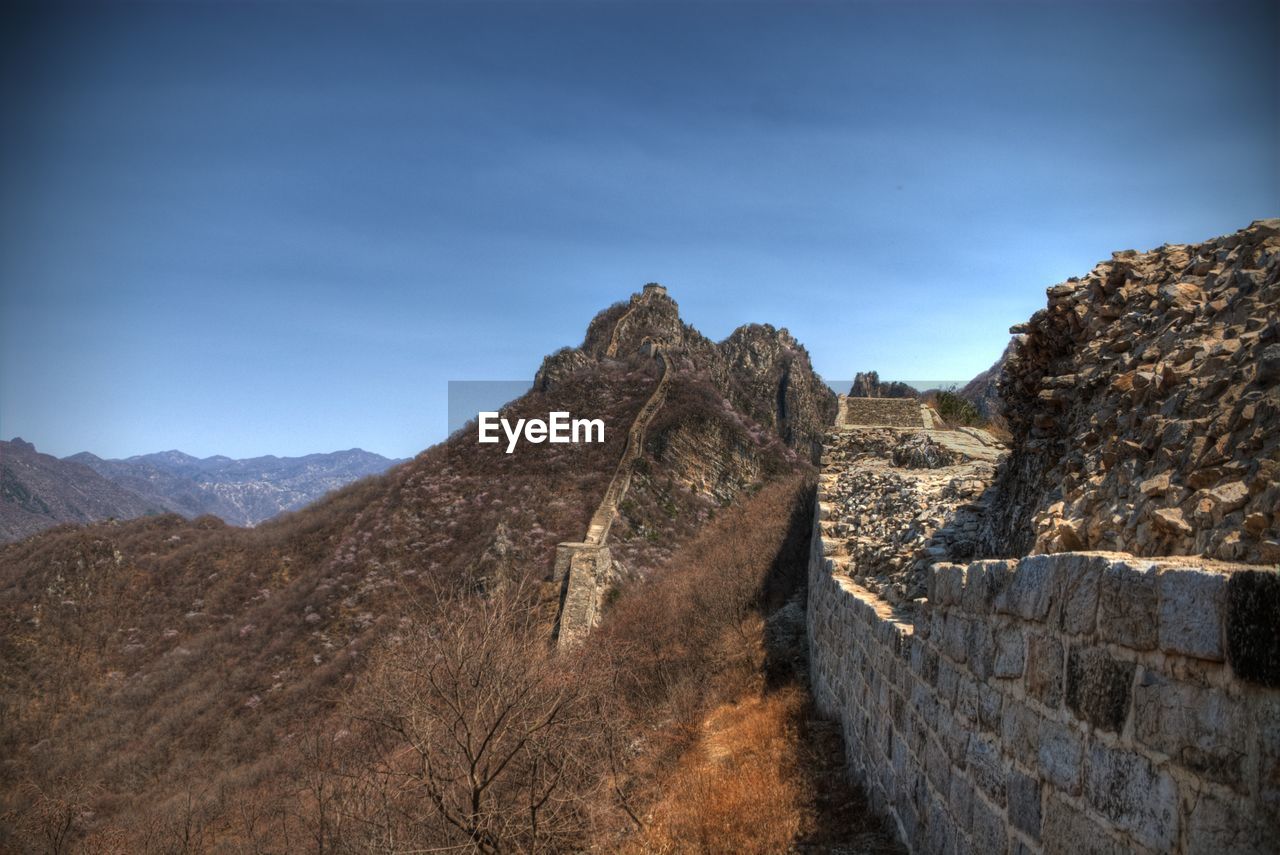 Great wall of china and mountain against blue sky