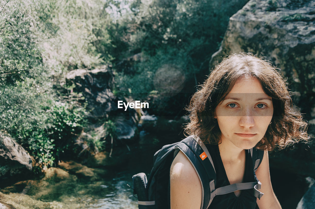 Girl sitting looking at camera in the mountains of prades, tarragona, spain