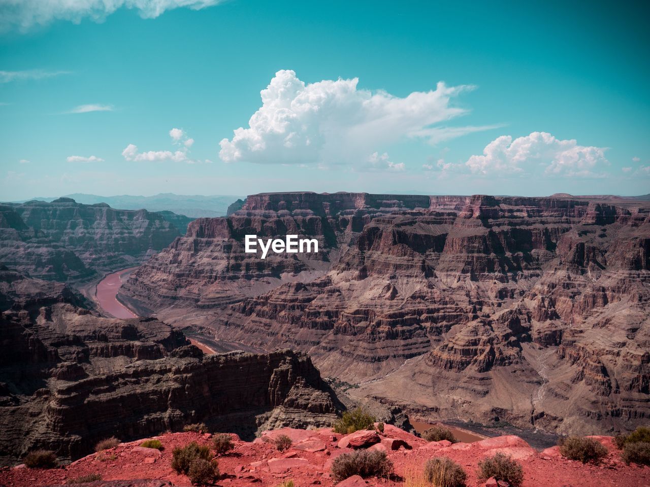 Scenic view of rock formations against cloudy sky