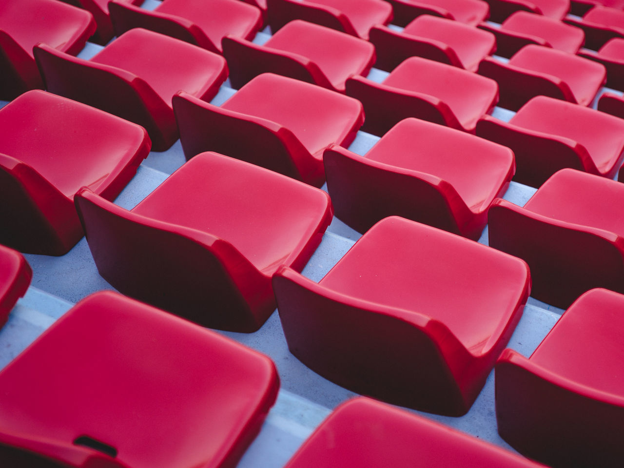 Full frame shot of red chairs in stadium