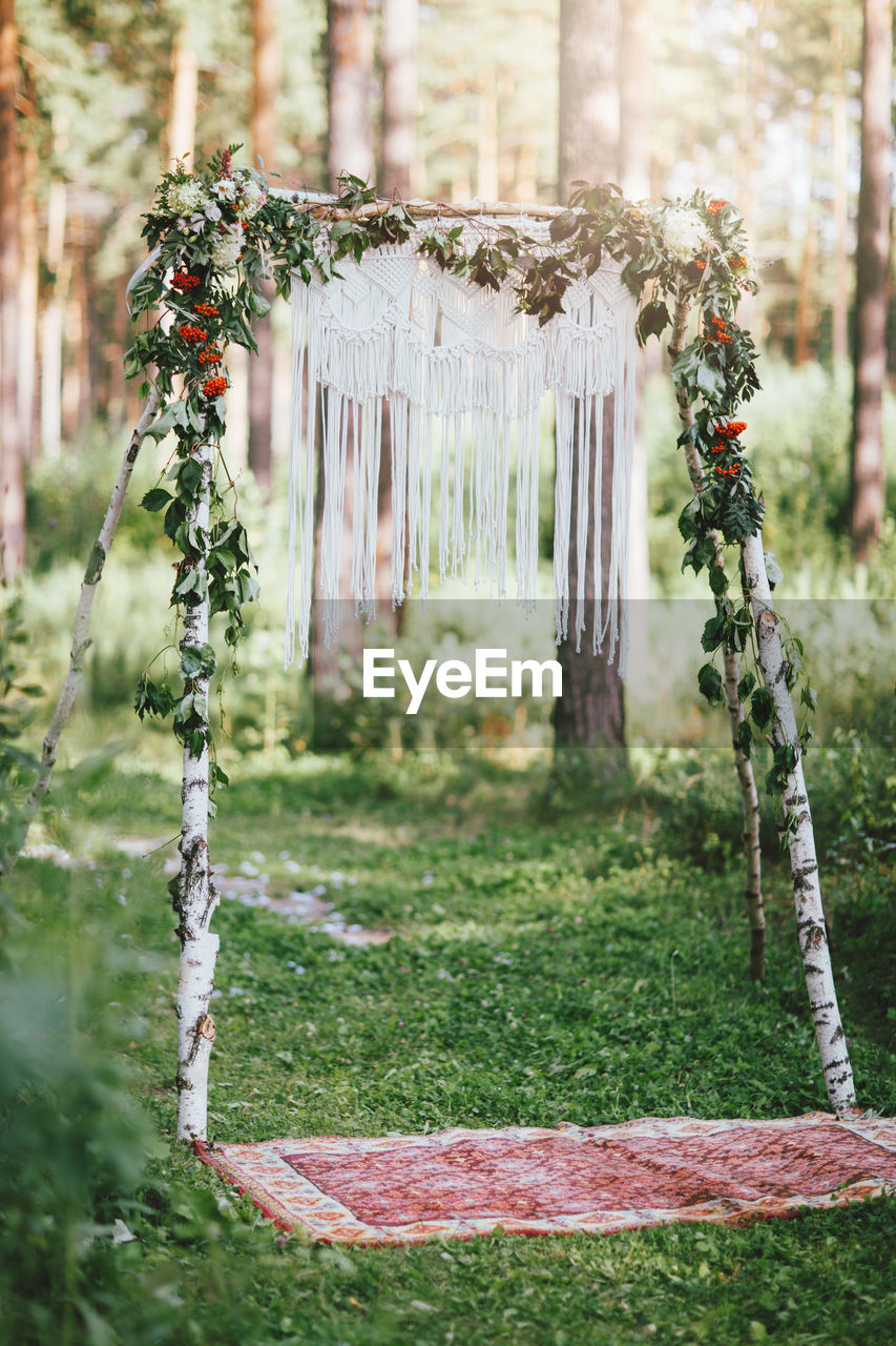 Wedding arch with macrame in the forest, boho style