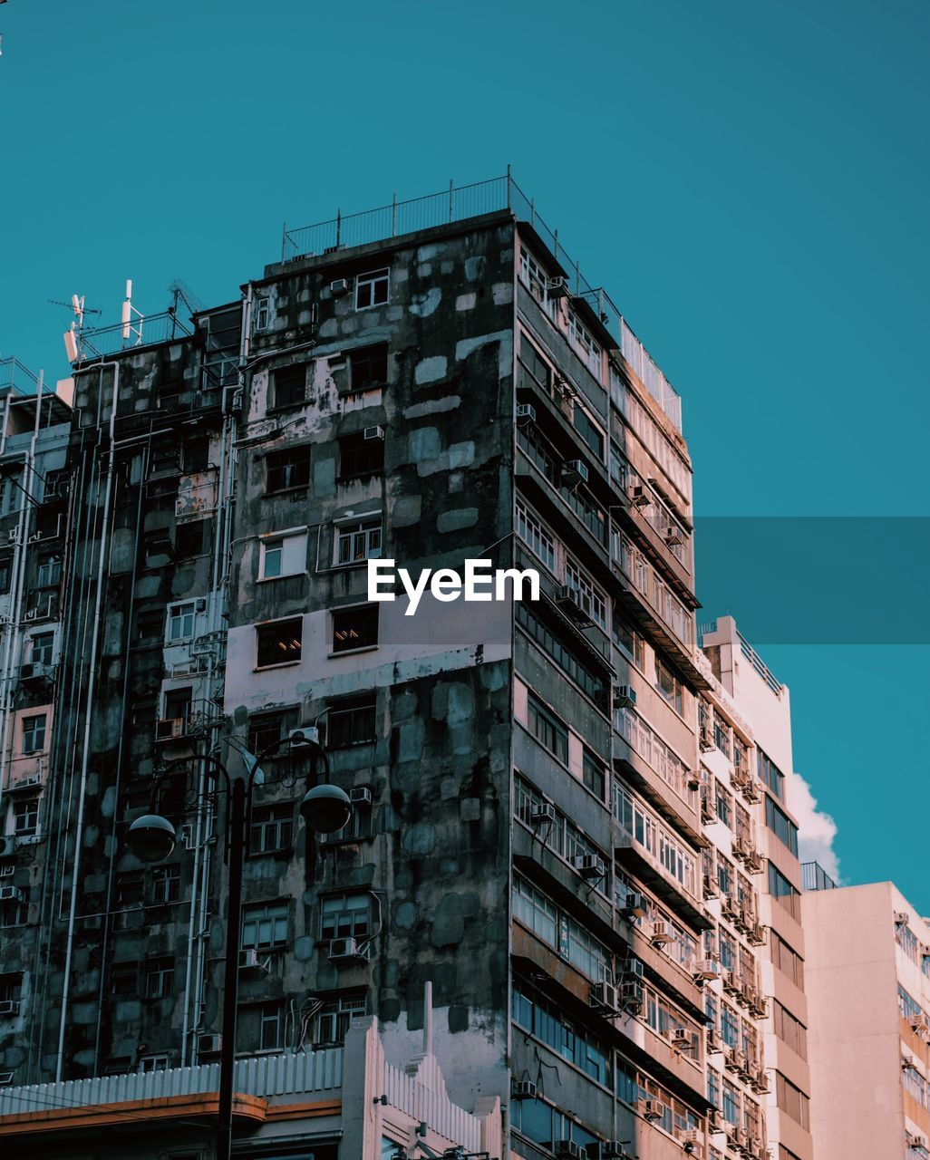 Low angle view of buildings against blue sky