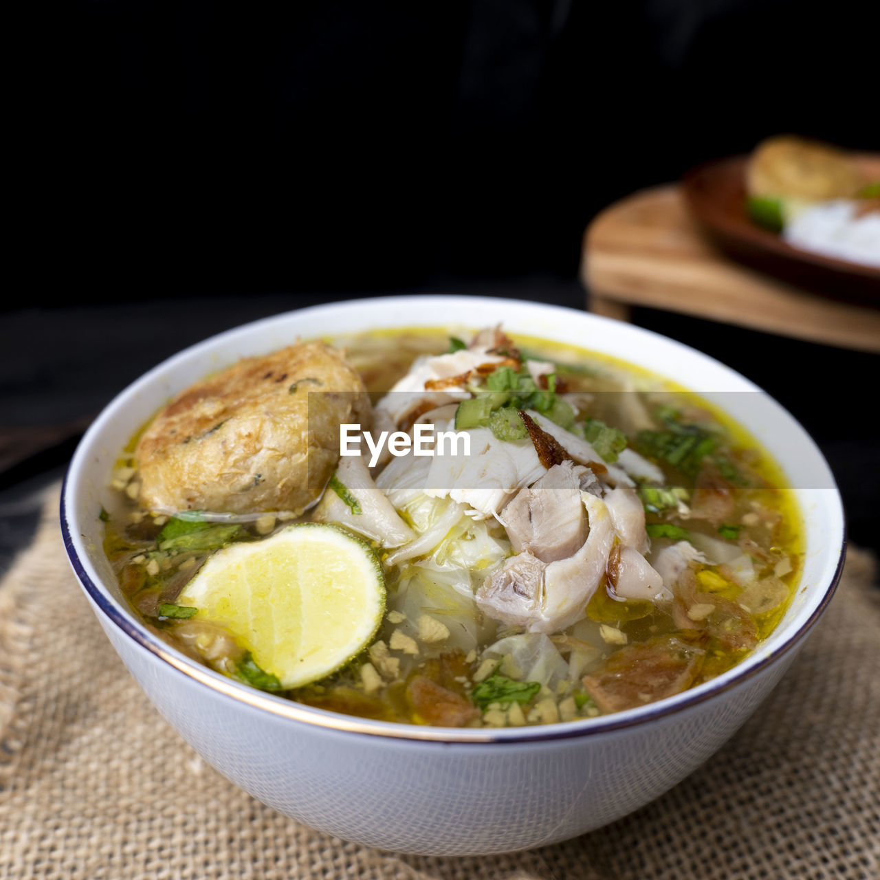 food and drink, food, healthy eating, wellbeing, soup, vegetable, bowl, freshness, dish, studio shot, meat, no people, asian food, indoors, cuisine, meal, produce, noodle soup, close-up, herb, curry, garnish, table, dinner, seafood, spice, black background, stew, savory food