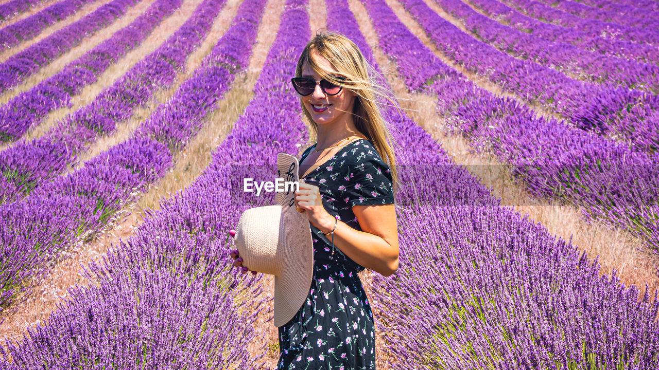 Close up of a young girl with a hat between lavender in southern provence valensole 