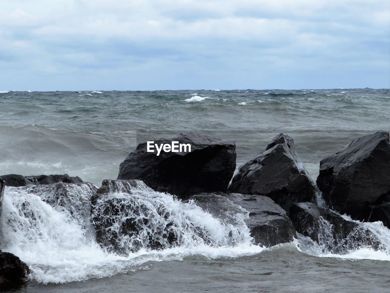 SEA WAVES SPLASHING ON ROCKS