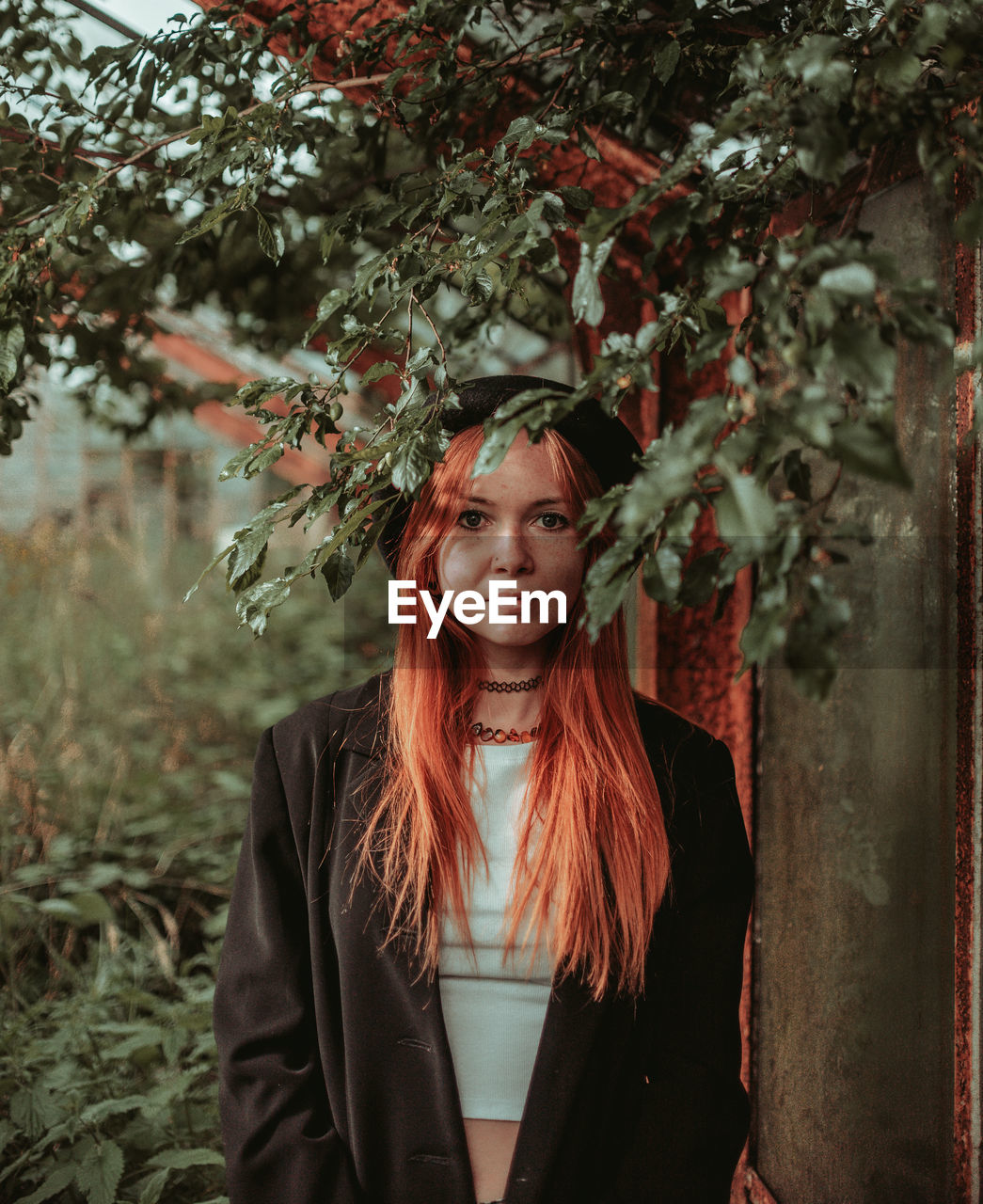 portrait of woman standing against trees