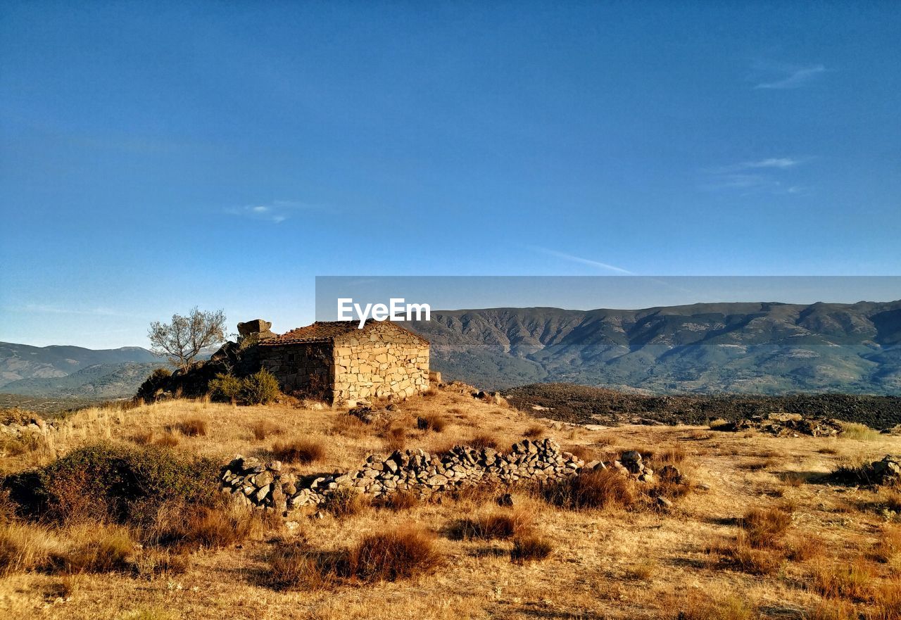 BUILT STRUCTURE ON FIELD AGAINST SKY