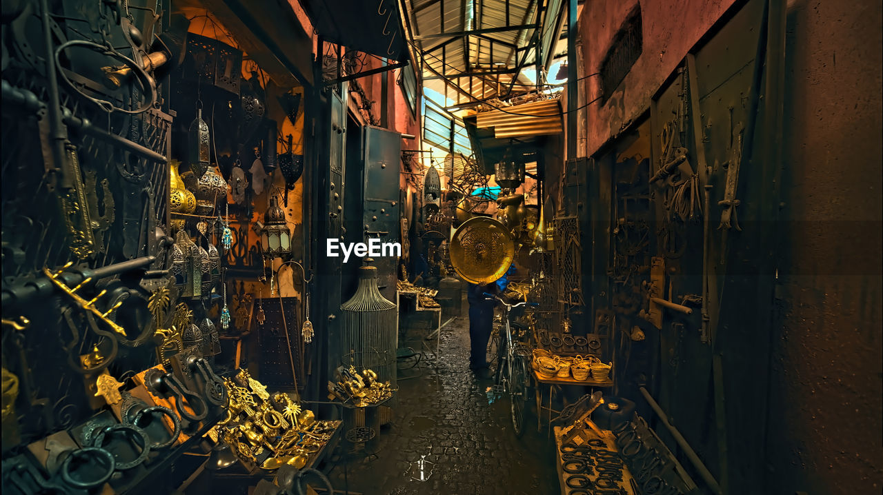 Rear view of people standing at illuminated market stall, morocco