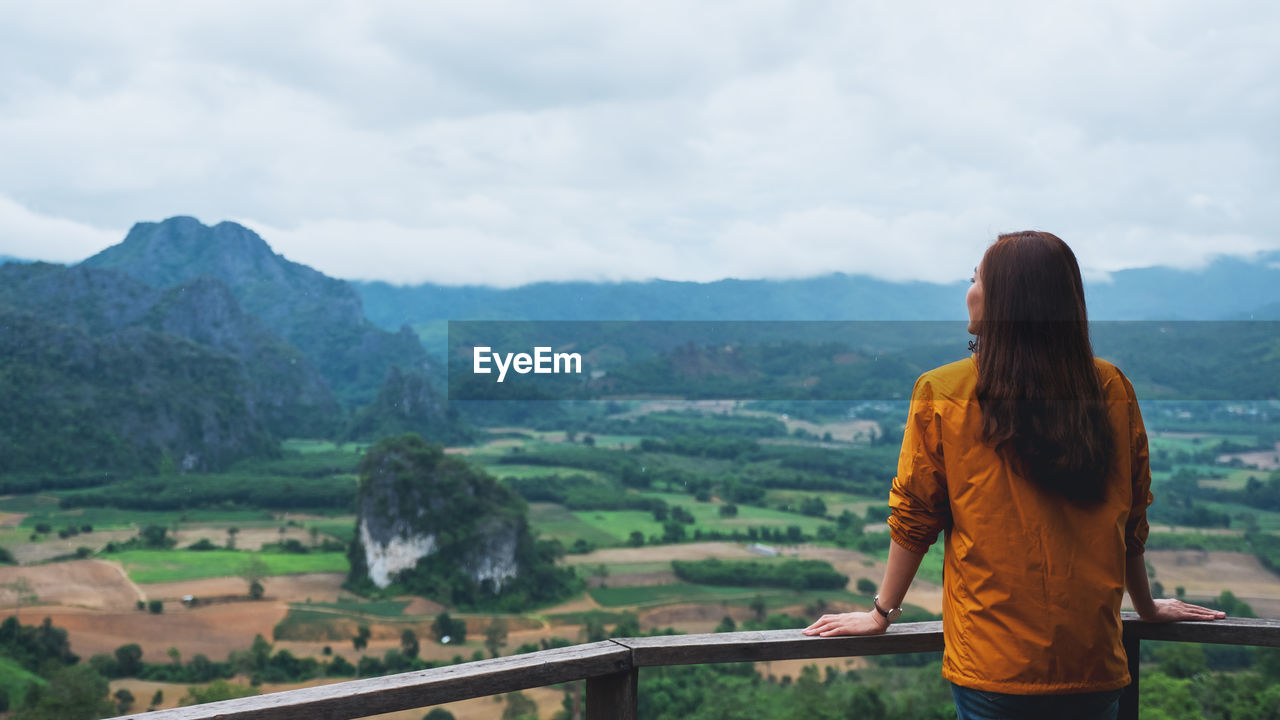 rear view of woman standing on mountain