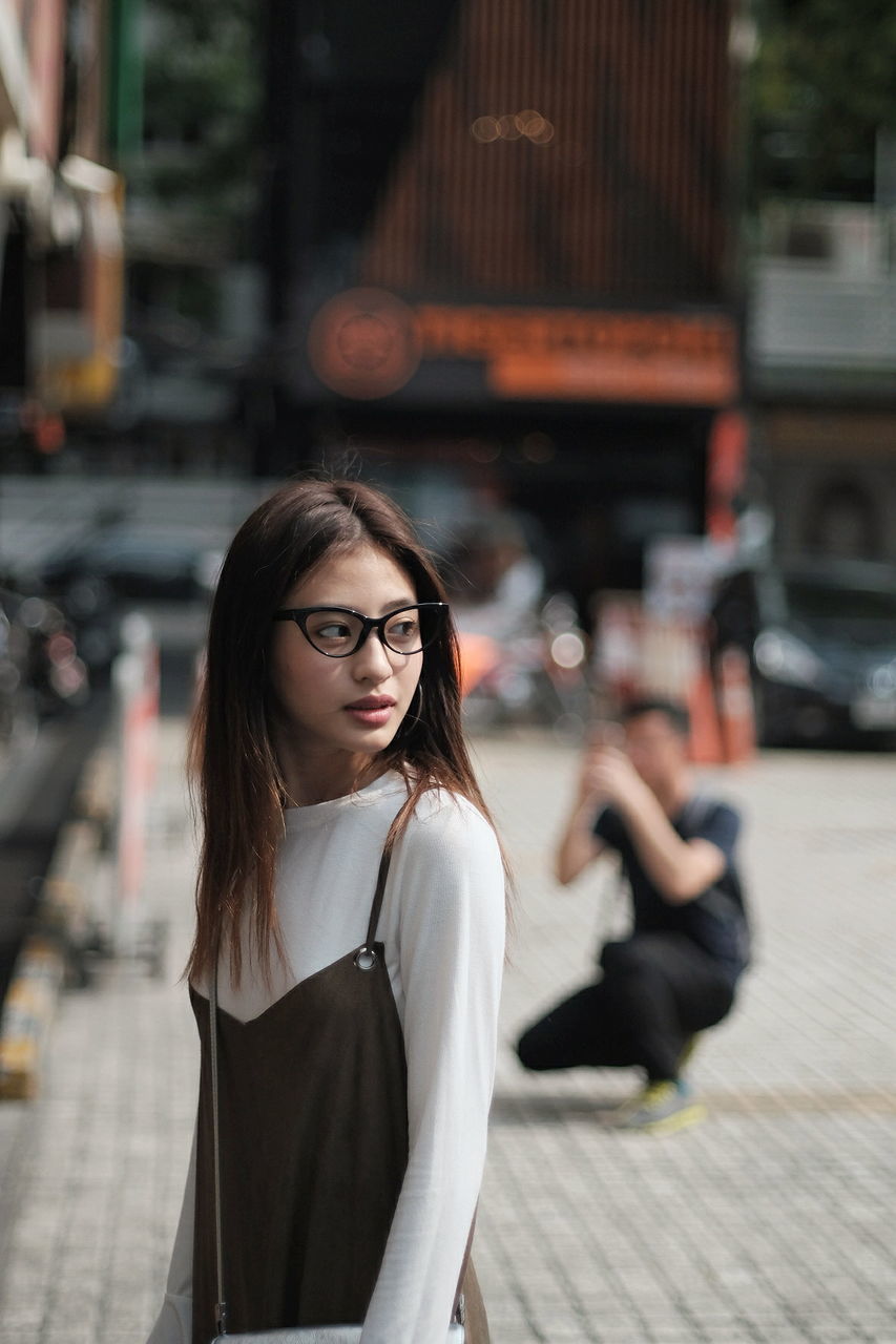 Portrait of beautiful woman standing on street