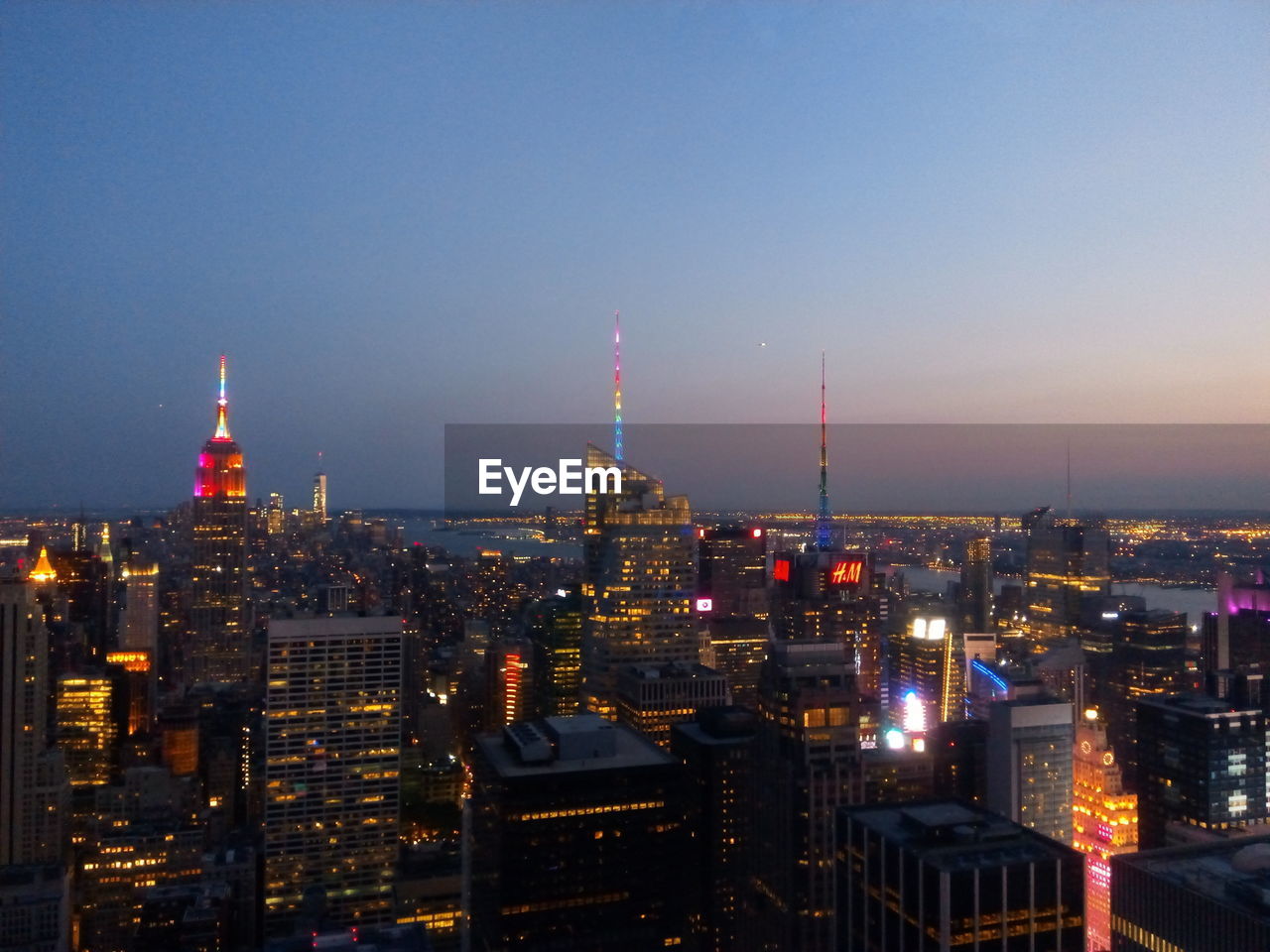 Illuminated cityscape against clear sky