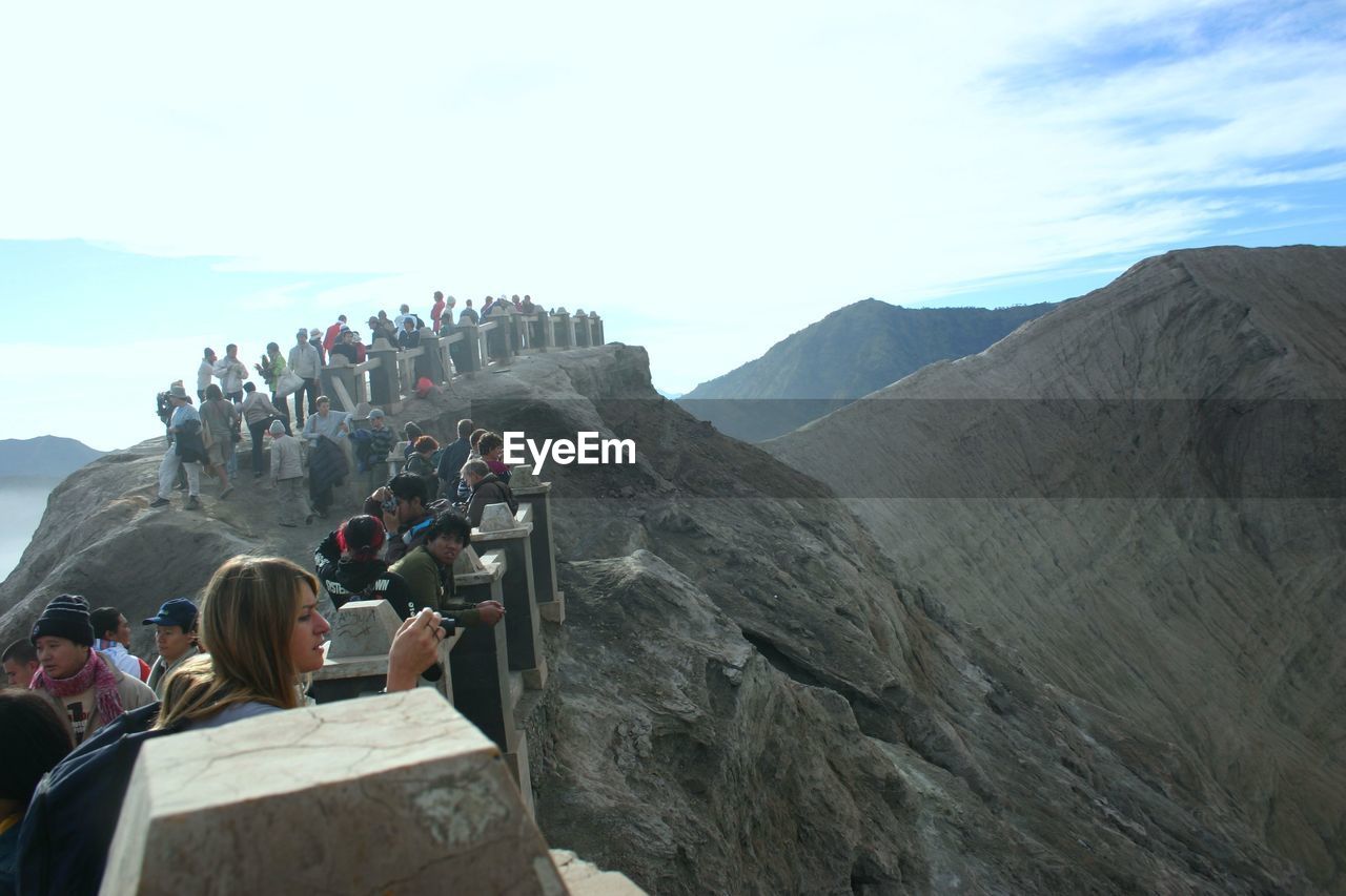 group of people, mountain, leisure activity, sky, nature, adult, travel, men, activity, women, travel destinations, large group of people, lifestyles, tourist, scenics - nature, adventure, tourism, crowd, beauty in nature, day, rock, mountaineering, environment, outdoors, landscape, vacation, extreme sports, trip, holiday, mountain range, hiking, land, climbing, person, architecture, photographing, summit, ridge, history, group, cloud