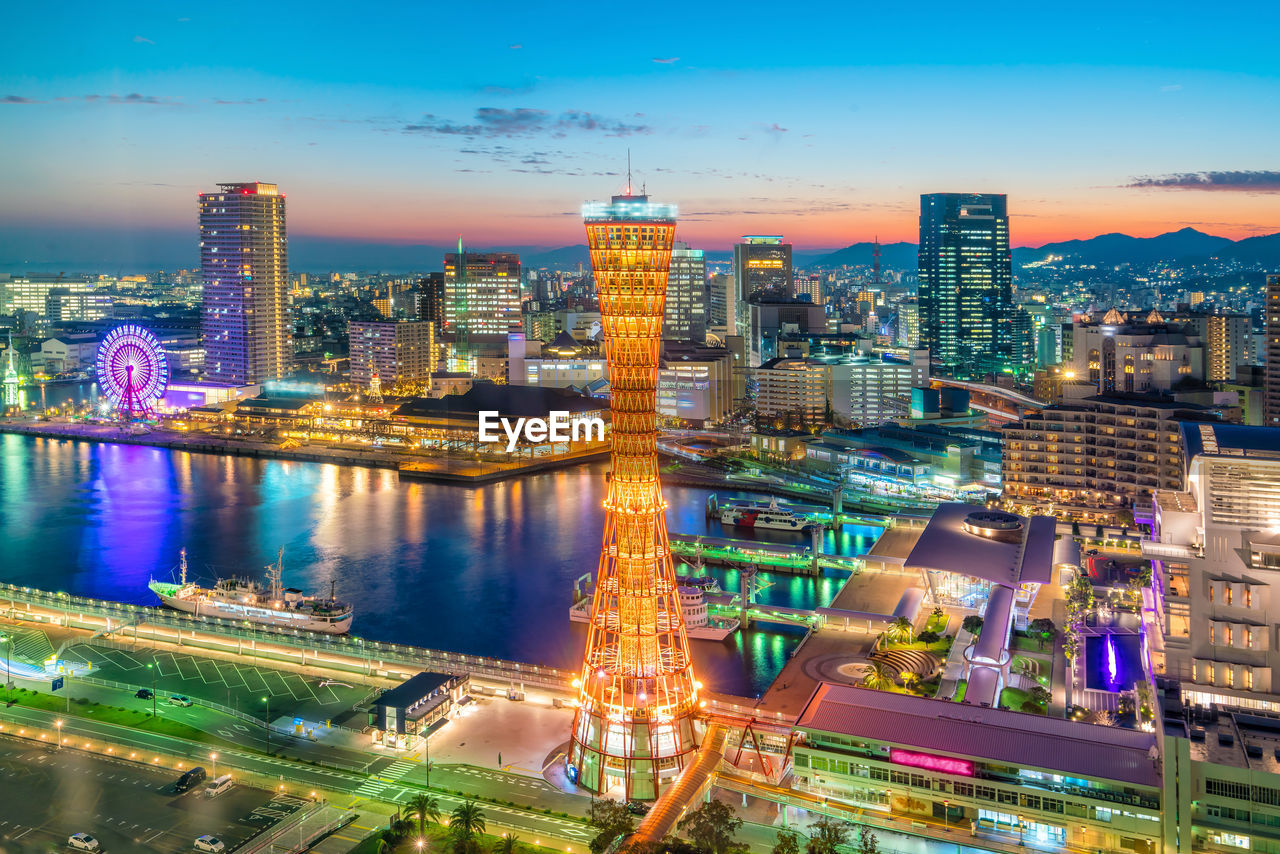 AERIAL VIEW OF ILLUMINATED CITY BUILDINGS AT NIGHT