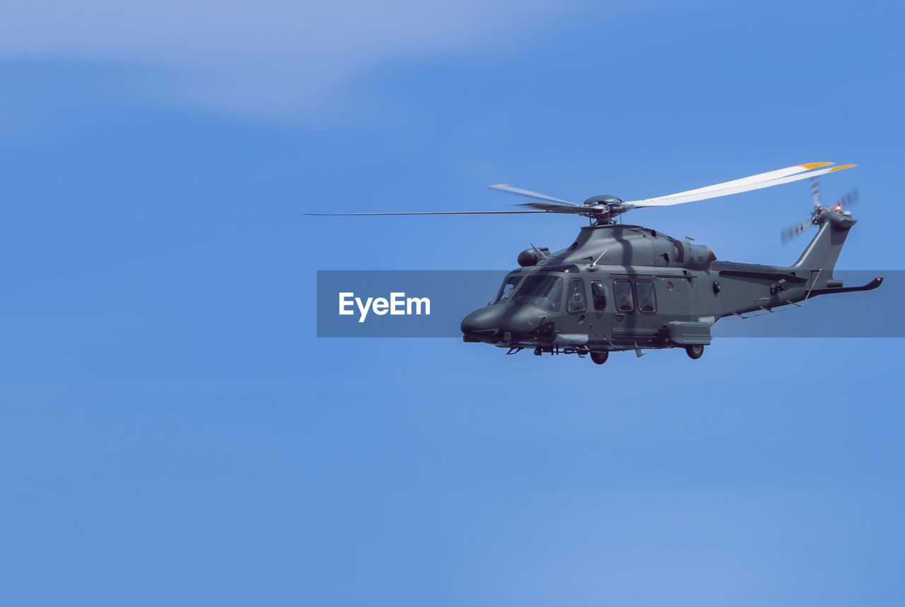 Low angle view of helicopter flying against clear sky