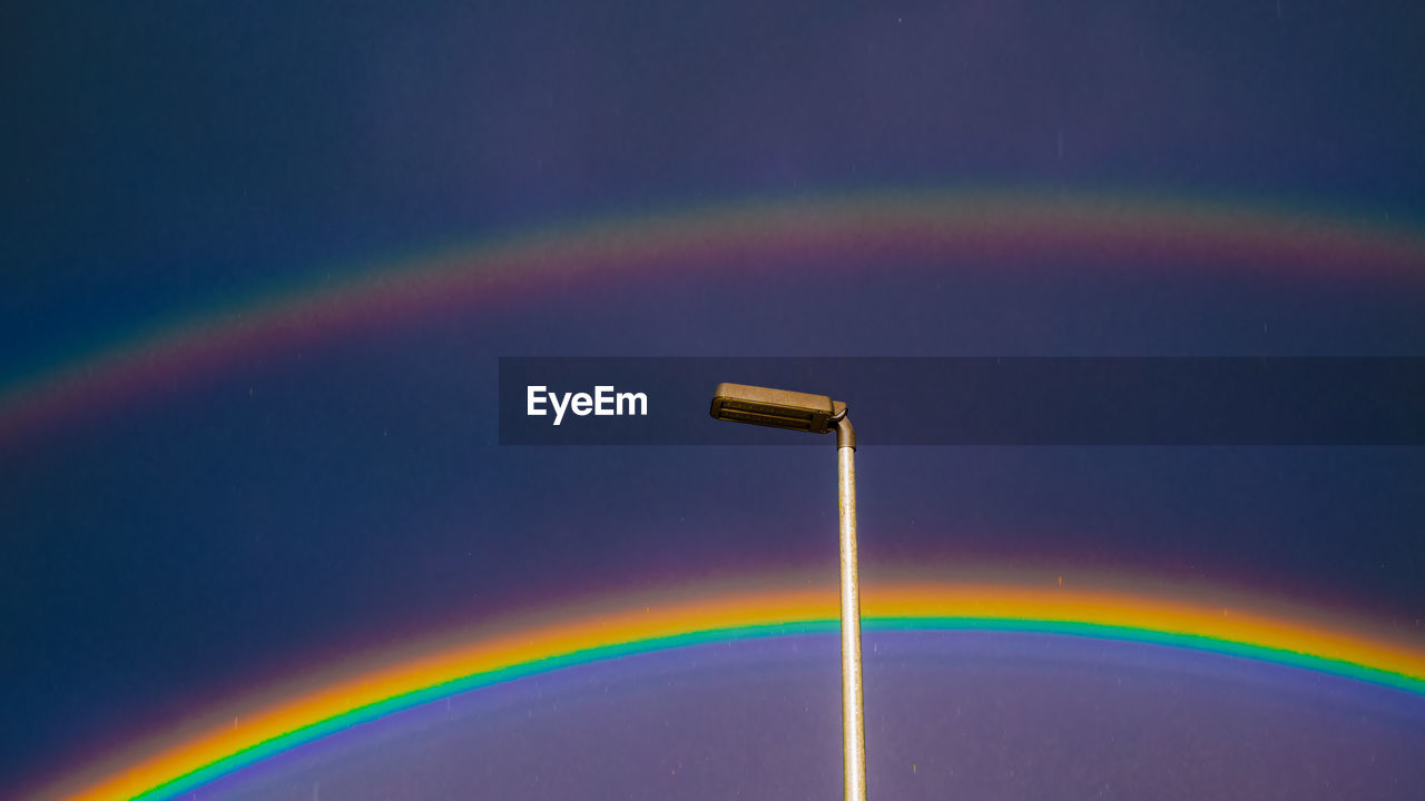 VIEW OF RAINBOW OVER WATER AGAINST SKY