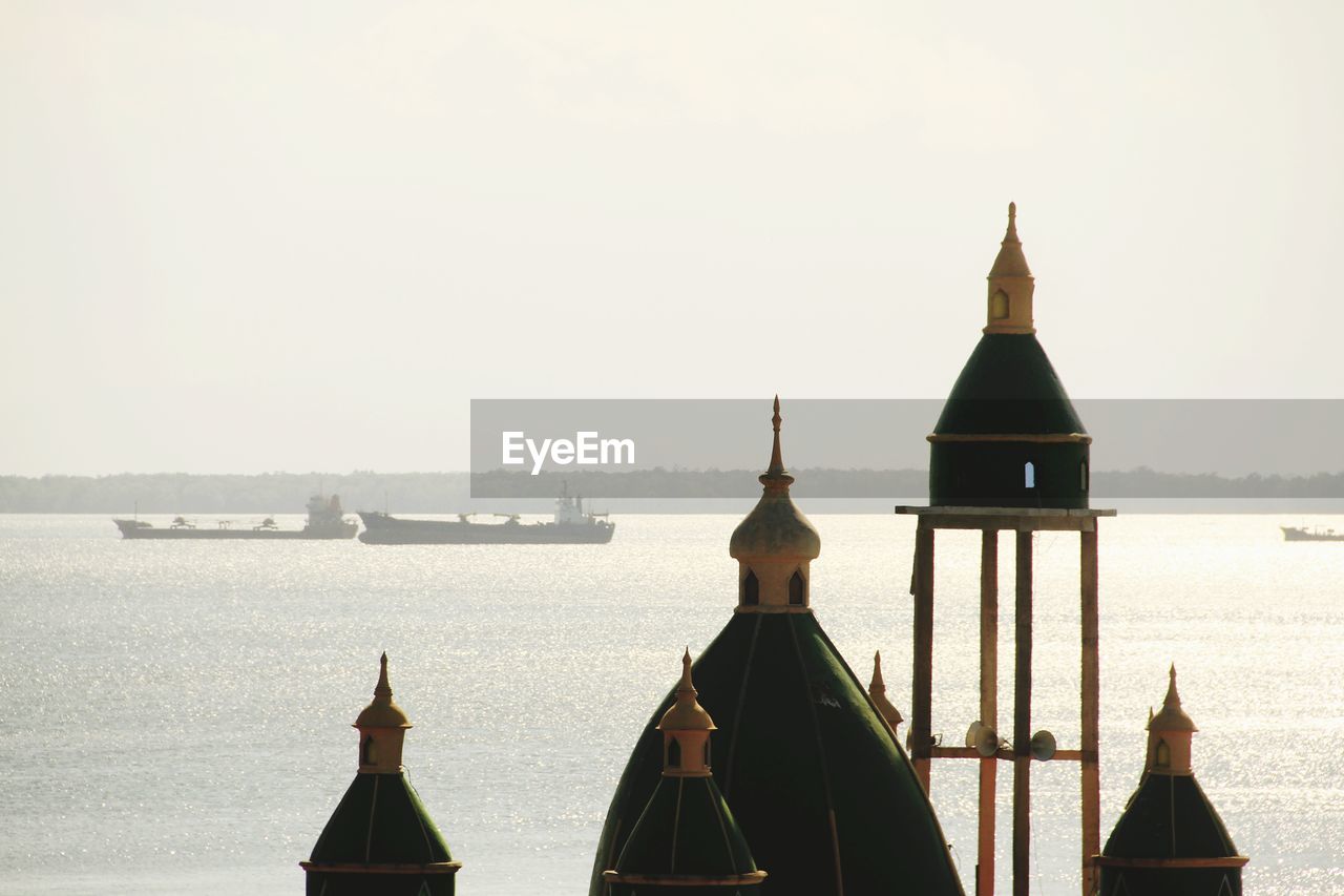 Panoramic view of sea and buildings against clear sky