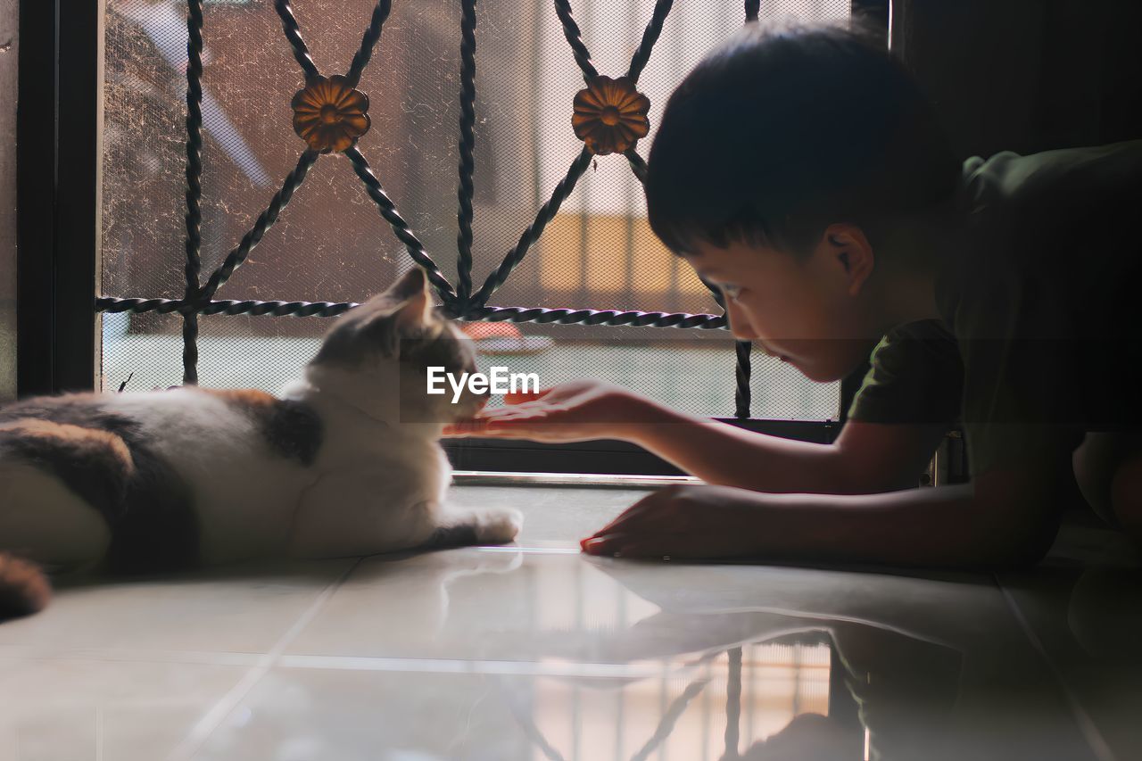 side view of boy looking at camera at home