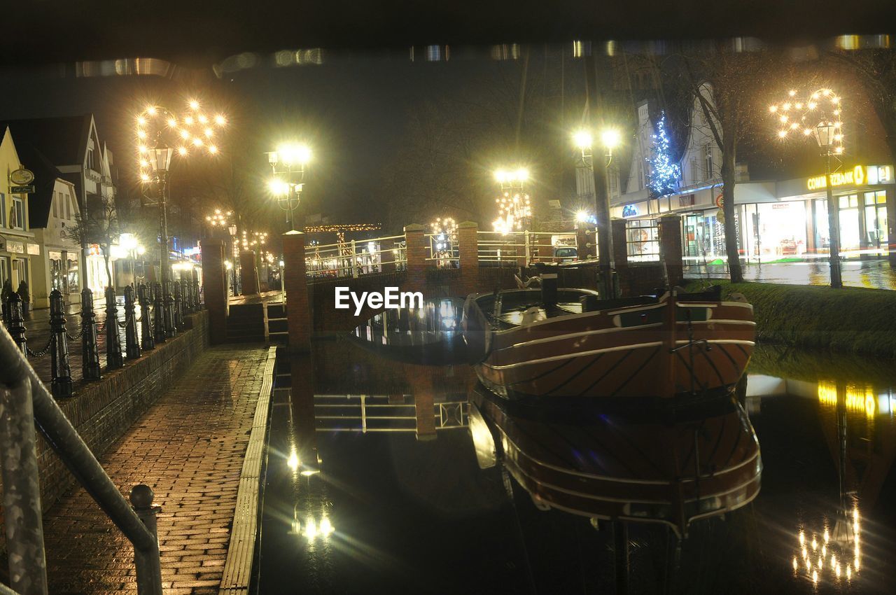 Motorboat in canal with lighting decoration reflection in water