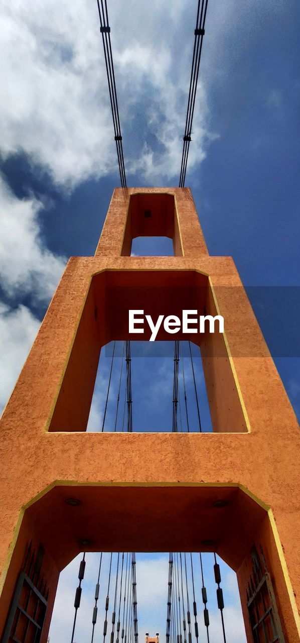 LOW ANGLE VIEW OF BRIDGE AGAINST BUILDINGS